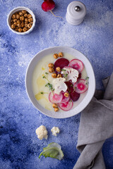 Cauliflower soup puree decorated with radish