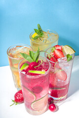 Iced refreshing drink. Bar and caffee beverage menu background. Set of various cold summer cocktails - peach tea, lemonade, mojito, cherry mocktail, with frruits on colorful bright blue background