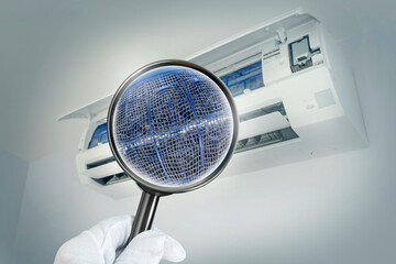 A simulated image of the inside of an air conditioner filter through a magnifying glass.