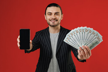 Young smiling successful rich latin man in black striped jacket grey shirt using mobile cell phone...