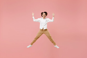 Fototapeta na wymiar Full length overjoyed young successful employee business woman 20s corporate lawyer in classic formal white shirt work in office jump high with outstretched hands isolated on pastel pink background