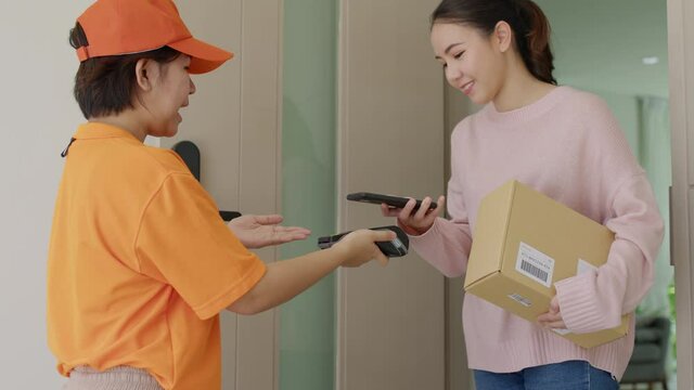 Asia young smile happy woman people receive parcel postal from e-commerce online shop store use tapping cashless wifi qr code nfc bill scan app smart pos device reader in city life home contactless.