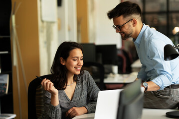 Colleagues in office. Businesswoman and businessman discussing work in office.