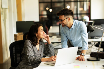 Colleagues in office. Businesswoman and businessman discussing work in office.