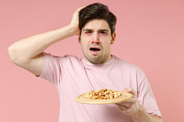 Sick unhealthy ill allergic man has red swelling watery eyes, runny stuffy sore nose suffer from...