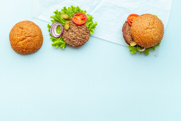 Fastfood meal - hamburgers with beef meat steak and vegetales. Top view