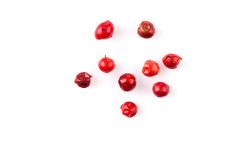 red peppercorns on white