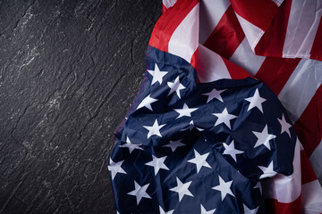 Concept of Independence day or Memorial day. Flag over dark slate table background.