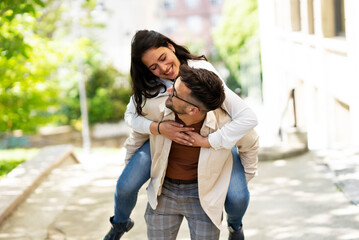 Fototapeta premium Happy young couple outdoors. Loving couple walking in the city.