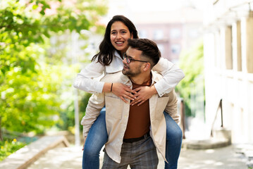 Happy young couple outdoors. Loving couple walking in the city.