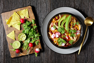Mexican chicken and tortilla soup on a black plate