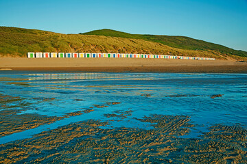 Rows of beach huts along Woolacombe Beach, voted amongst the world's beat