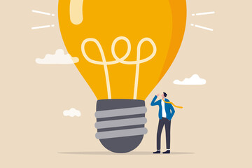 Think big, aspiration to win and success in business, big idea from creativity and imagination to overcome fear concept, smart businessman entrepreneur thinking with big oversized idea lightbulb. © Nuthawut