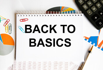 In the notebook, the text is Back to Basics, next to the pen, calculator, paper clips, diagrams and graphs.