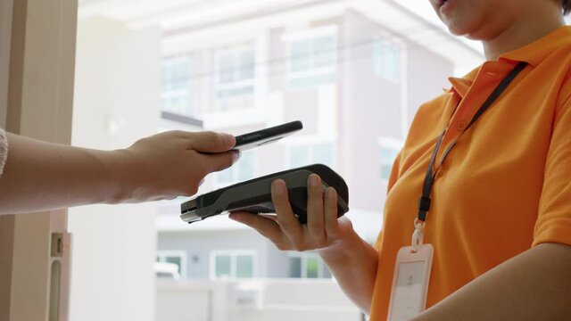 Asia young smile happy woman people receive parcel postal from e-commerce online shop store use tapping cashless wifi qr code nfc bill scan app smart pos device reader in city life home contactless.