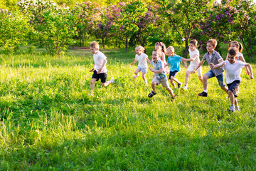 Fototapeta premium children play outdoors running and having fun