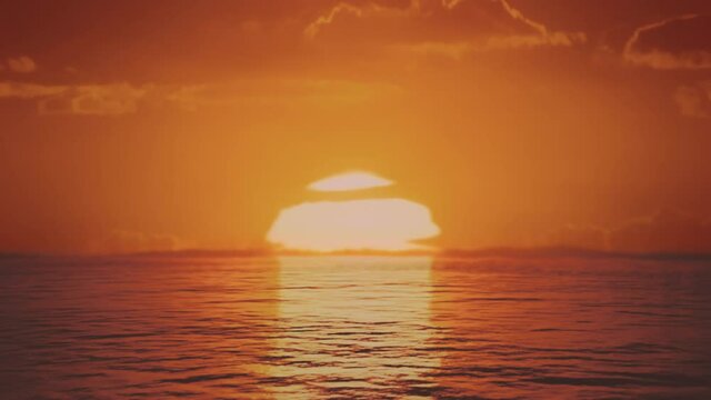 Aerial shot of rising sun reflecting in endless water surface, ocean or lake. 