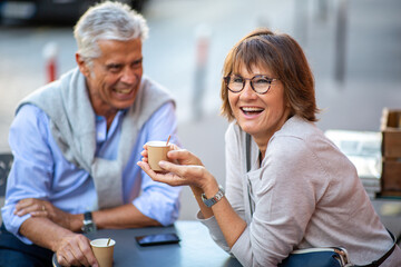 older couple enjoying cup of coffee outside