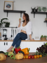  young woman nutritionist prepares a delicious and healthy breakfast. Cuts salad, vitamins, vegetables and fruits