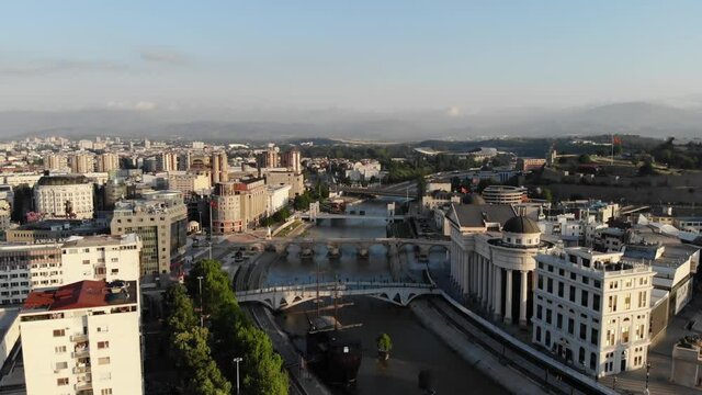 A panoramic view from a drone of the embankment of the city of Skopje in northern Macedonia. Drone view of the bridges over the Vardar River. Fly over a city in Macedonia. Ship restaurant on the river