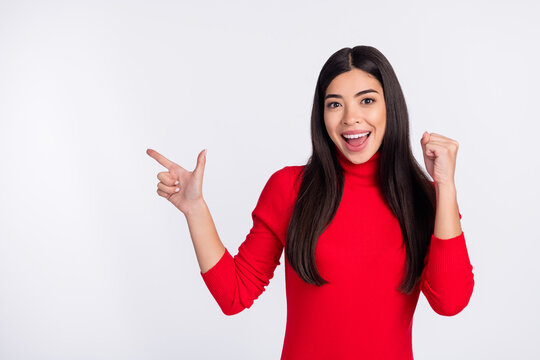 Photo of happy excited good mood young woman advertising product point finger copyspace isolated on grey color background