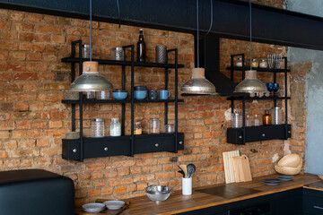 Top view on open space industrial loft kitchen with vintage decor and black cabinets