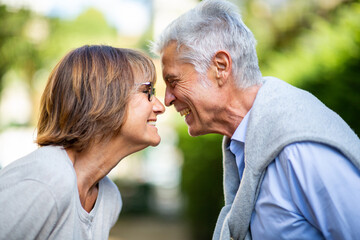 Profile of older couple smiling face to face