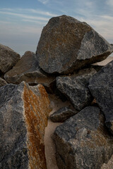 stones that lie on the beach on the sand, against the blue sky