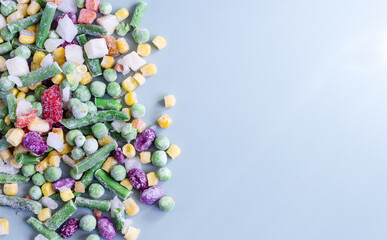Frozen vegetables on a colored background top view. Food concept in the pandemic frozen vegetables kopi space
