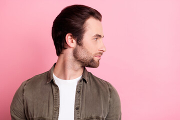 Profile side photo of young handsome guy serious confident look empty space isolated over pink color background