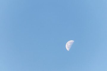 the moon in a clear blue sky