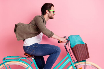 Profile side photo of young guy happy positive smile ride bicycle trip fast look empty space...