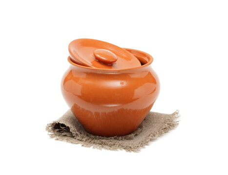 Clay pot for cooking and napkin on white