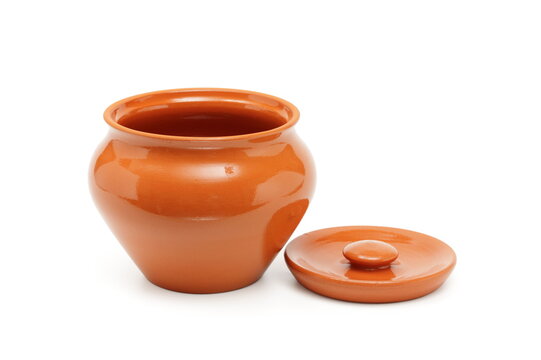 open clay pot for cooking on white