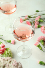 Glasses of pink wine and beautiful flowers