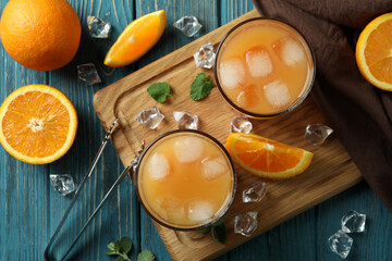 Tequila Sunrise cocktails and ingredients on wooden table