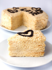Traditional layered Napoleon cake on a white background. Close-up.