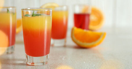 Tequila sunrise cocktails on white textured table, close up