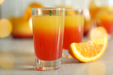 Tequila sunrise cocktails on white textured table, close up