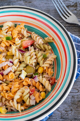 Pasta salad with tuna, egg, tomato, corn and olives