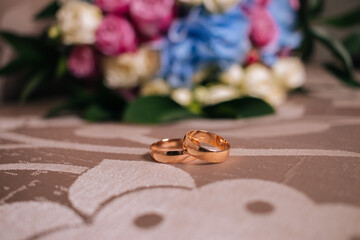 the Hands of brides with gold wedding rings close up	