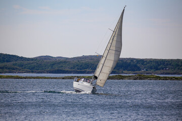 Obraz premium Sailboat with wind in the sails along the Norwegian coast,Helgeland,Nordland county,Norway,scandinavia,Europe