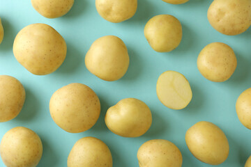 Fototapeta na wymiar Tasty young potato on blue background, top view