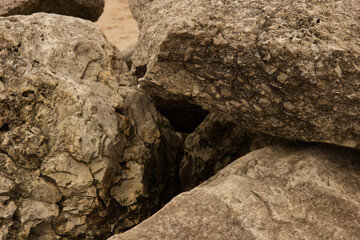 Naklejka premium Close up of large rocks on a sandy beach