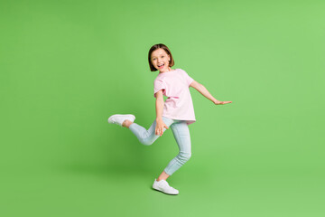 Fototapeta na wymiar Full body profile side photo of young excited girl happy positive smile enjoy music dance isolated over green color background
