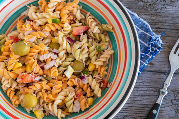 Pasta salad with tuna, egg, tomato, corn and olives