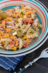 Pasta salad with tuna, egg, tomato, corn and olives