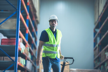 A man woker using forklift in warehouse, foreman wearing helmet and safety vest in storehouse,...