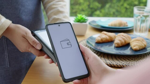 Asia young smile happy woman people in small sme coffee shop store use tapping cashless wifi qr code nfc scan app smart pos device reader sale in food drink order in caf&eacute; urban city life contactless.