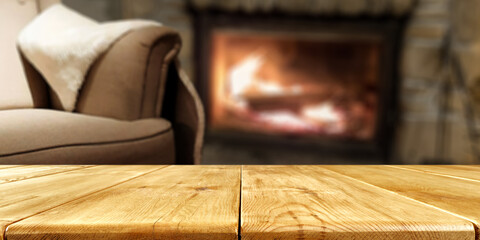 Wooden table of free space and home interior with fireplace 